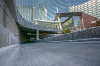 a skateboarder is skating on a paved walkway outside a building and near by