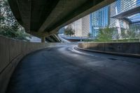 an overpass of a freeway in a city with tall buildings and blue sky in the background