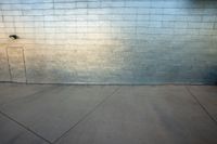 a skateboarder is jumping up in the air in front of a brick wall