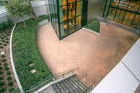 a view from above shows several steps with plants, bushes and stairs to the outside