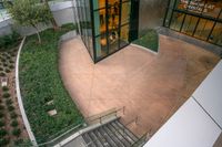 a view from above shows several steps with plants, bushes and stairs to the outside