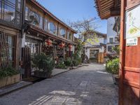 the street with pots is very narrow and beautiful, and is lined up all along with many buildings