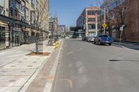 the cars are lined up on this city street in front of a building with many windows