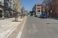 the cars are lined up on this city street in front of a building with many windows