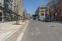 the cars are lined up on this city street in front of a building with many windows