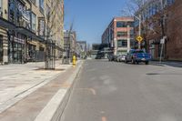 the cars are lined up on this city street in front of a building with many windows