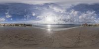 view of the ocean and a very large beach from an upside down fish eye lens