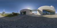 the 360 - panorama view shows the building on a hill side with a circular window