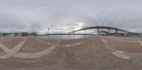 a panoramic photo of a bridge on a cloudy day with no people around it