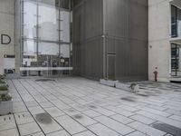 an entrance and window in a building with tiled flooring and glass walls, looking at the outside