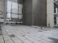 an entrance and window in a building with tiled flooring and glass walls, looking at the outside