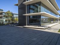 an outside view of some building with many windows and concrete patio areas area for outdoor seating