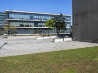 there is a skate board in the grass on a skateboard park surface in front of the building