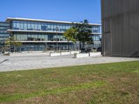 there is a skate board in the grass on a skateboard park surface in front of the building