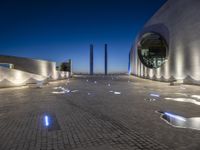 the building is lit up with many different things on it and features white lights and blue