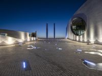 the building is lit up with many different things on it and features white lights and blue