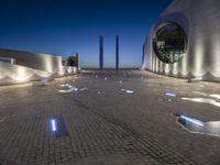 the building is lit up with many different things on it and features white lights and blue
