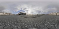 the spherical view is very high in the sky, it has clouds around the building