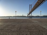 the bridge spans over to another island with the sun on it's horizon in view