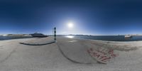 an image of a fish eye view of the water in a bay with graffiti on the sand