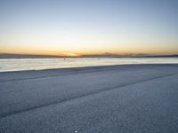 the person is riding a bicycle on the beach at sunset timesign to get some exercise in the water