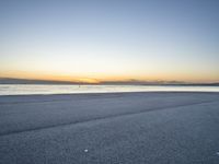 the person is riding a bicycle on the beach at sunset timesign to get some exercise in the water