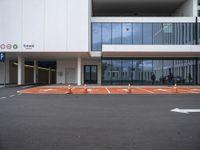 the ground in front of this building is painted orange to give a pop - up effect