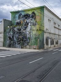 a building with two side walls painted green with graffiti of a man riding on a horse