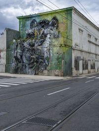 a building with two side walls painted green with graffiti of a man riding on a horse