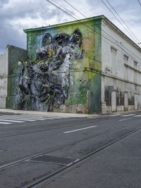 a building with two side walls painted green with graffiti of a man riding on a horse