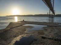 Lisbon Harbor at Dawn with Clear Sky and Sun Burst