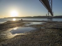 Lisbon Harbor at Dawn with Clear Sky and Sun Burst