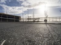 a brick walkway leads to a dock near an empty parking lot on the waterfront area