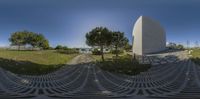 360 view of a circular walkway outside a museum, and park area in front of the monument