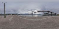 the view of the bridge through fisheye lens, which is being reflected in water