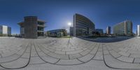 an outdoor view of the city through the fish eye lens filter lens by person with skate board