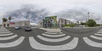 an intersection view looking toward the sky and buildings in the background from the 360 - angle view point on a street