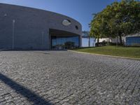 a stone patio with concrete circles on it's sides, and trees behind them