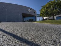 a stone patio with concrete circles on it's sides, and trees behind them