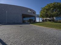 a stone patio with concrete circles on it's sides, and trees behind them