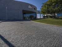 a stone patio with concrete circles on it's sides, and trees behind them