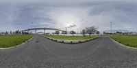 a fisheye lens is showing a view of the road in a wide angle and the sky in the background