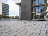 the square tile on the building's outside surface is shown, along with modern buildings in the background