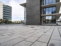 the square tile on the building's outside surface is shown, along with modern buildings in the background