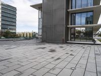 the square tile on the building's outside surface is shown, along with modern buildings in the background