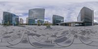 circular panorama panoramic image of a square with a building in the background and many large buildings in the distance