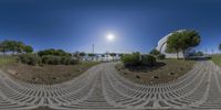 this is a 360 - view of the sun shining in a park area with stone steps and green grass