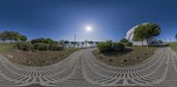 this is a 360 - view of the sun shining in a park area with stone steps and green grass