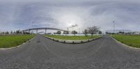 a fisheye lens is showing a view of the road in a wide angle and the sky in the background