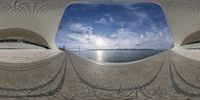 a view of a huge building next to the ocean taken in a fisheye lens